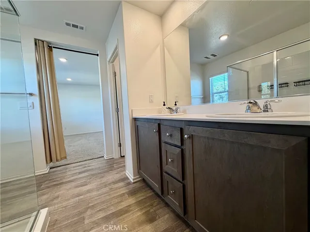 a en suite bathroom with a sink and mirror