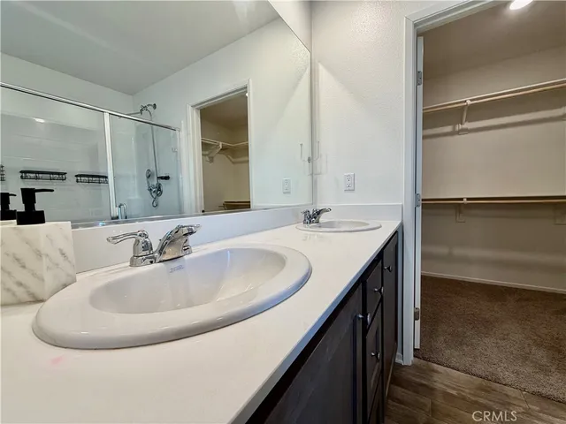 a bathroom with a double vanity sink and a mirror