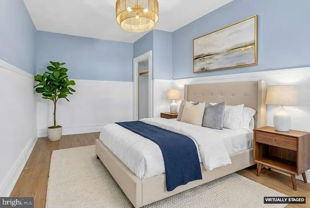 a bedroom with bed and a potted plant