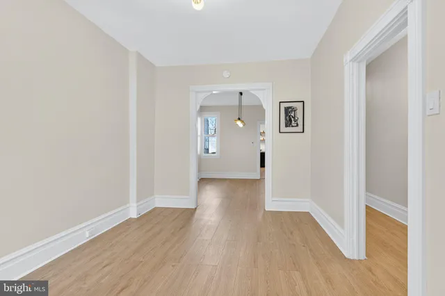 a view of a hallway with wooden floor