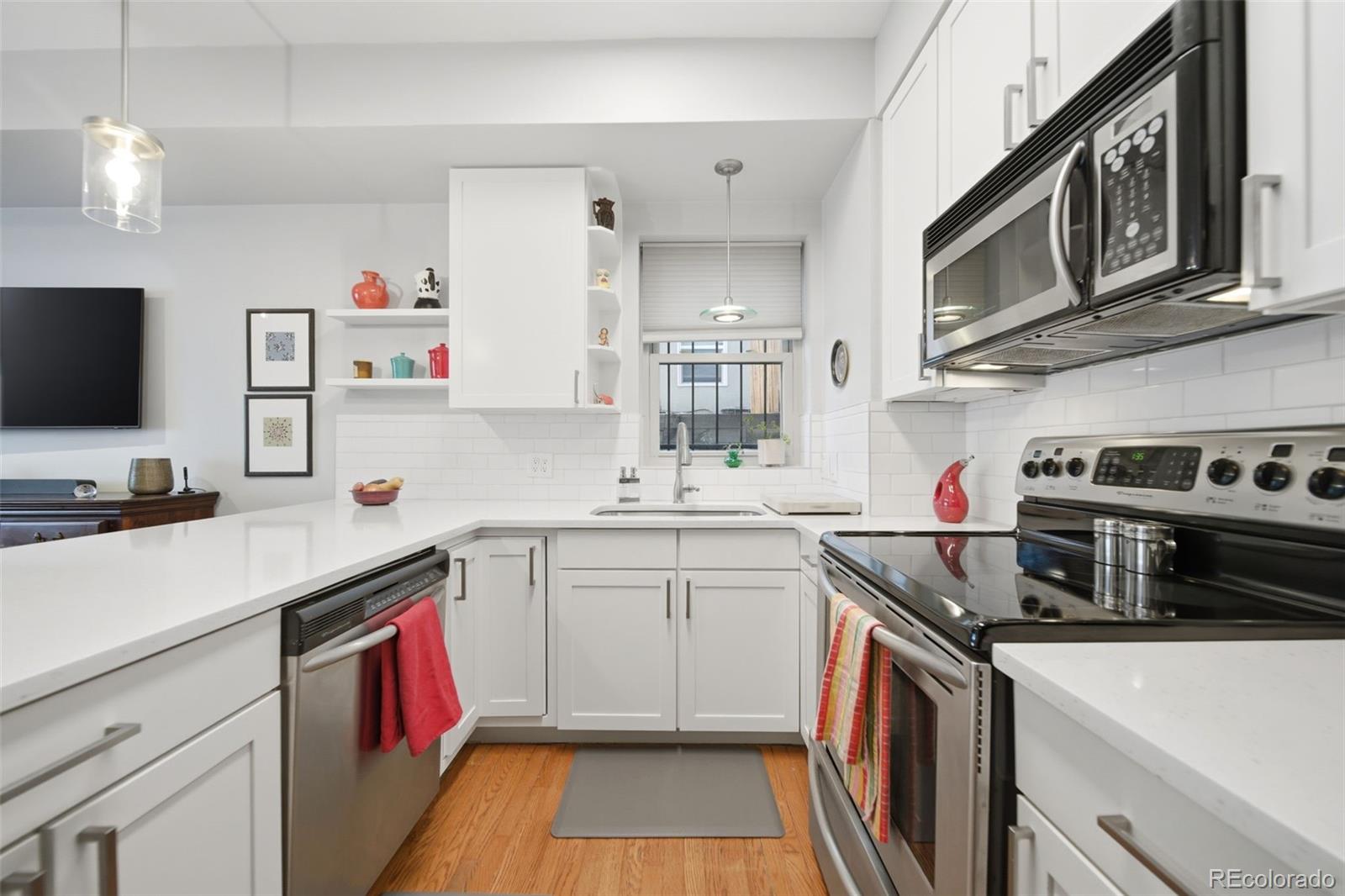 3045 Umatilla Street Denver, CO 80211 - Photo 11 of 48 a kitchen with a sink stove and microwave