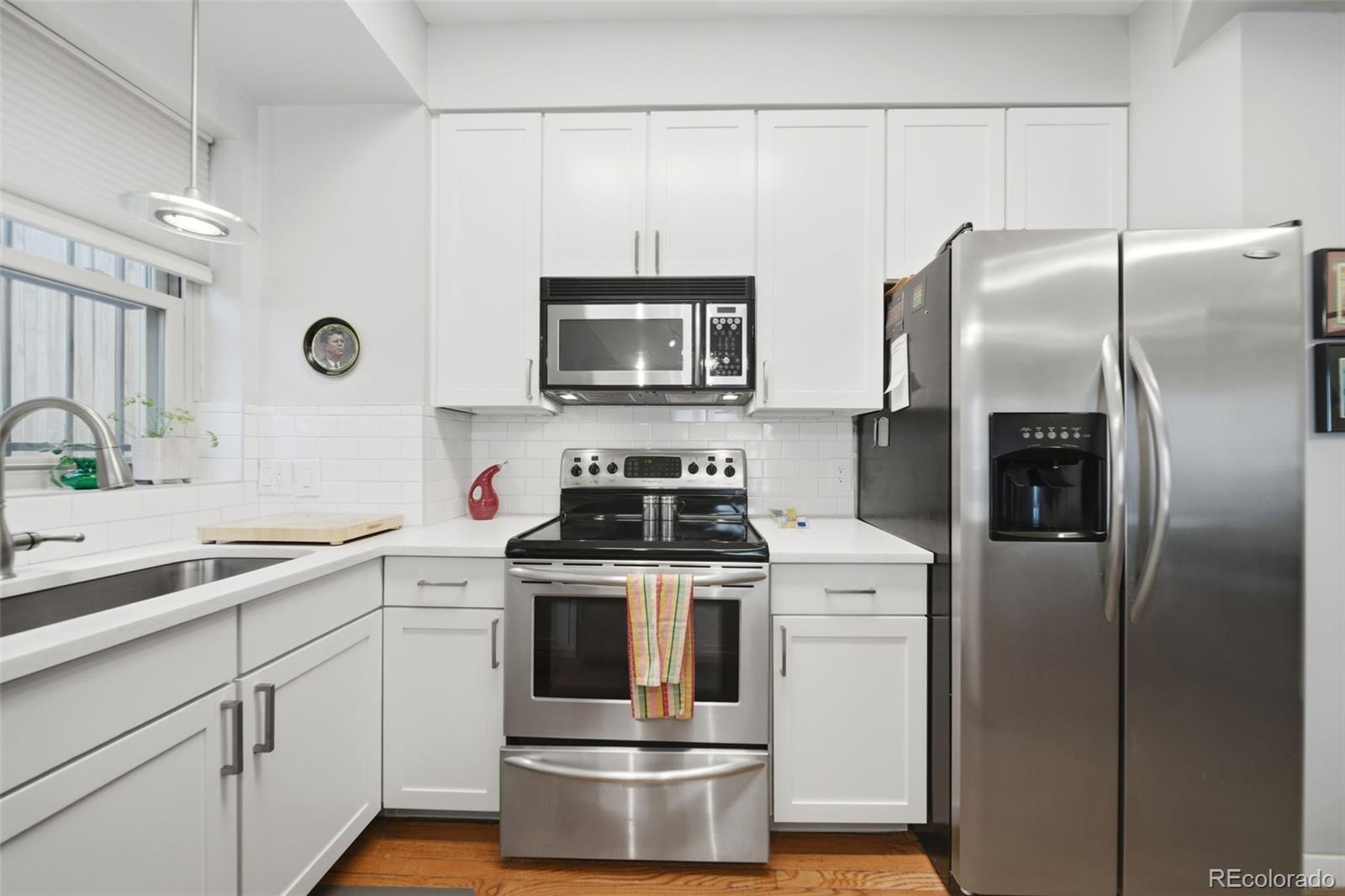 3045 Umatilla Street Denver, CO 80211 - Photo 14 of 48 a kitchen with a stove top oven and refrigerator
