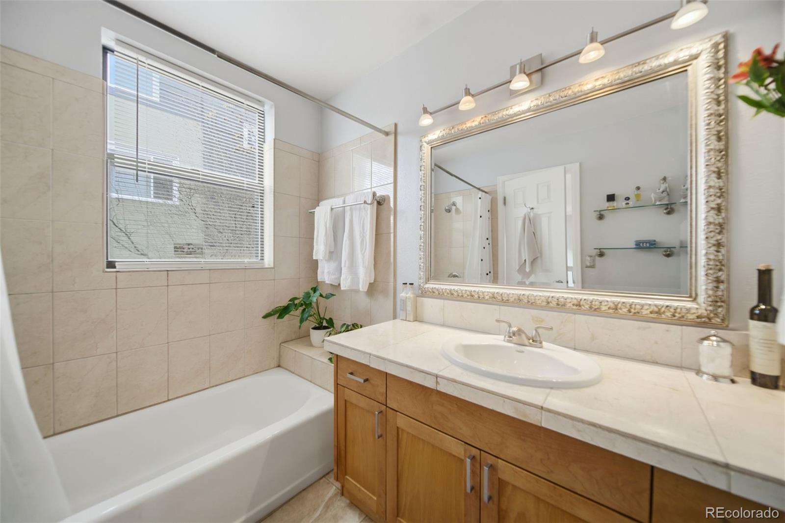 3045 Umatilla Street Denver, CO 80211 - Photo 18 of 48 a bathroom with a sink a bathtub and a mirror