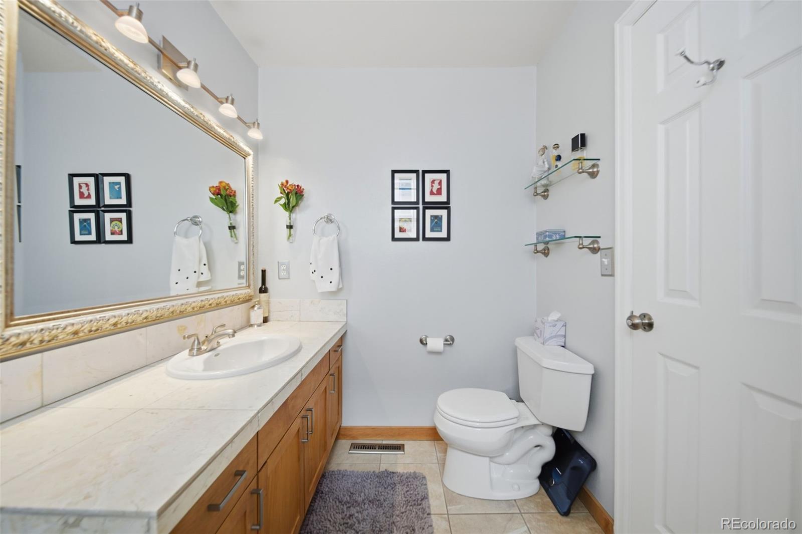 3045 Umatilla Street Denver, CO 80211 - Photo 19 of 48 a bathroom with a double vanity sink toilet and shower