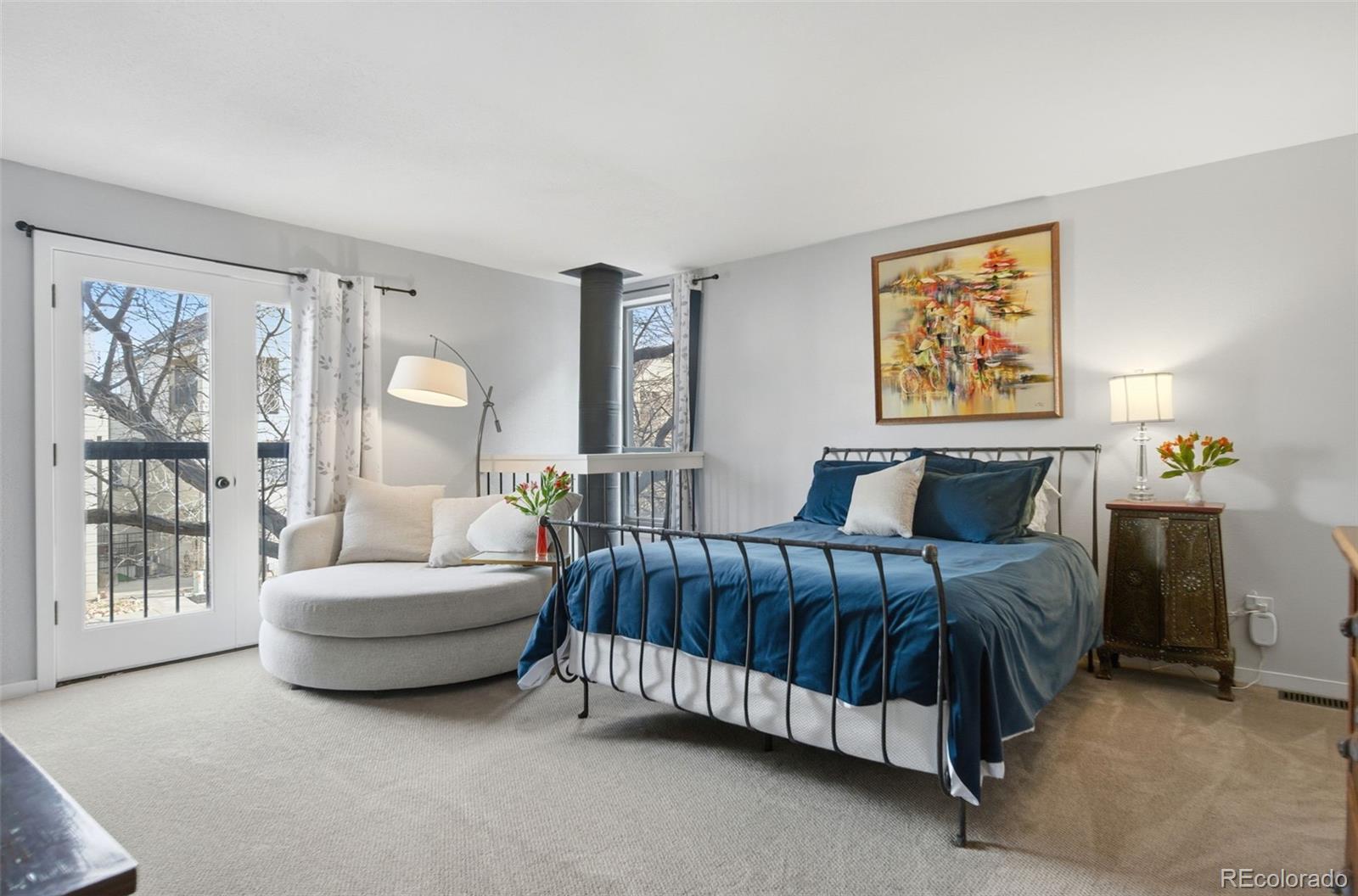 3045 Umatilla Street Denver, CO 80211 - Photo 21 of 48 a spacious bedroom with a bed and a couch