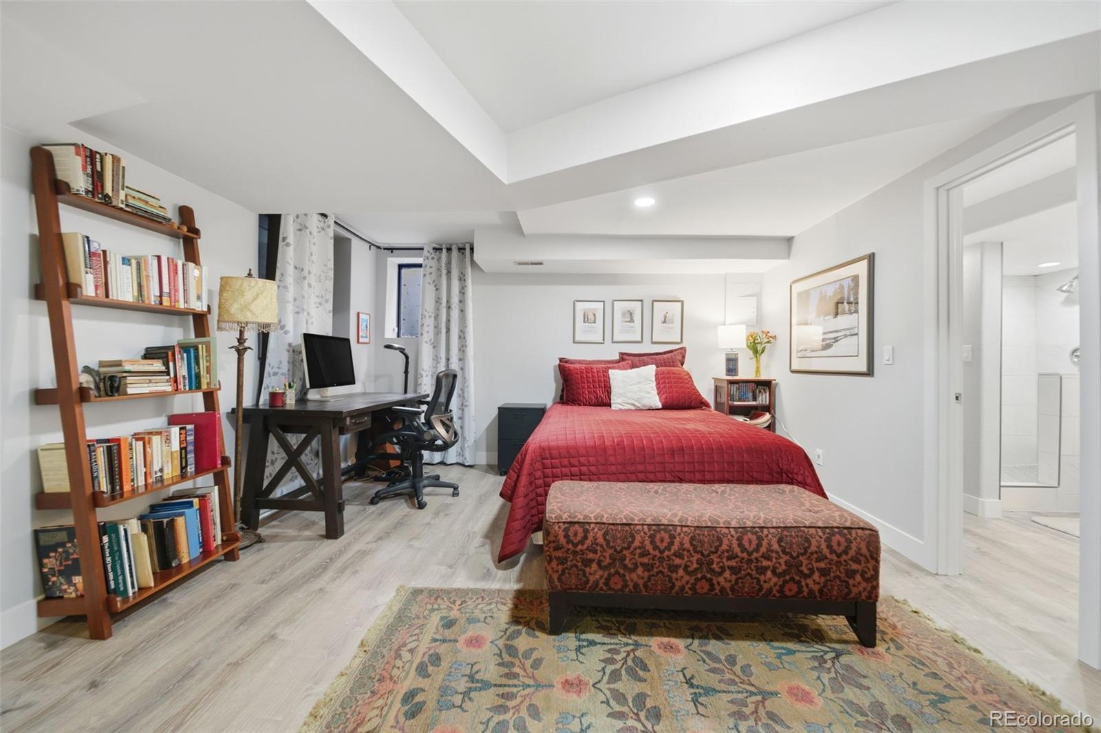3045 Umatilla Street Denver, CO 80211 - Photo 23 of 48 a bedroom with a bed a book shelf and a window