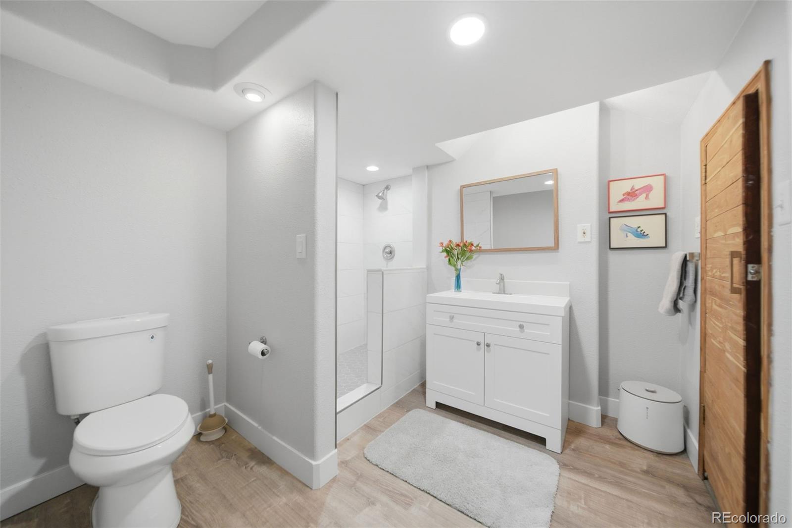 3045 Umatilla Street Denver, CO 80211 - Photo 26 of 48 a bathroom with a toilet sink and mirror