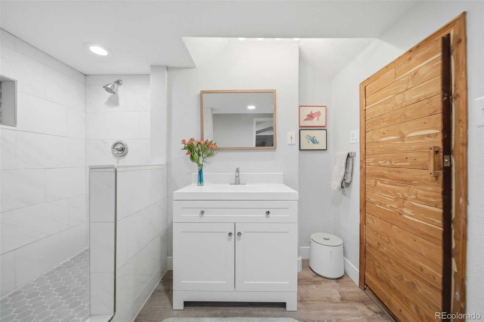 3045 Umatilla Street Denver, CO 80211 - Photo 27 of 48 a bathroom with a sink a toilet and shower