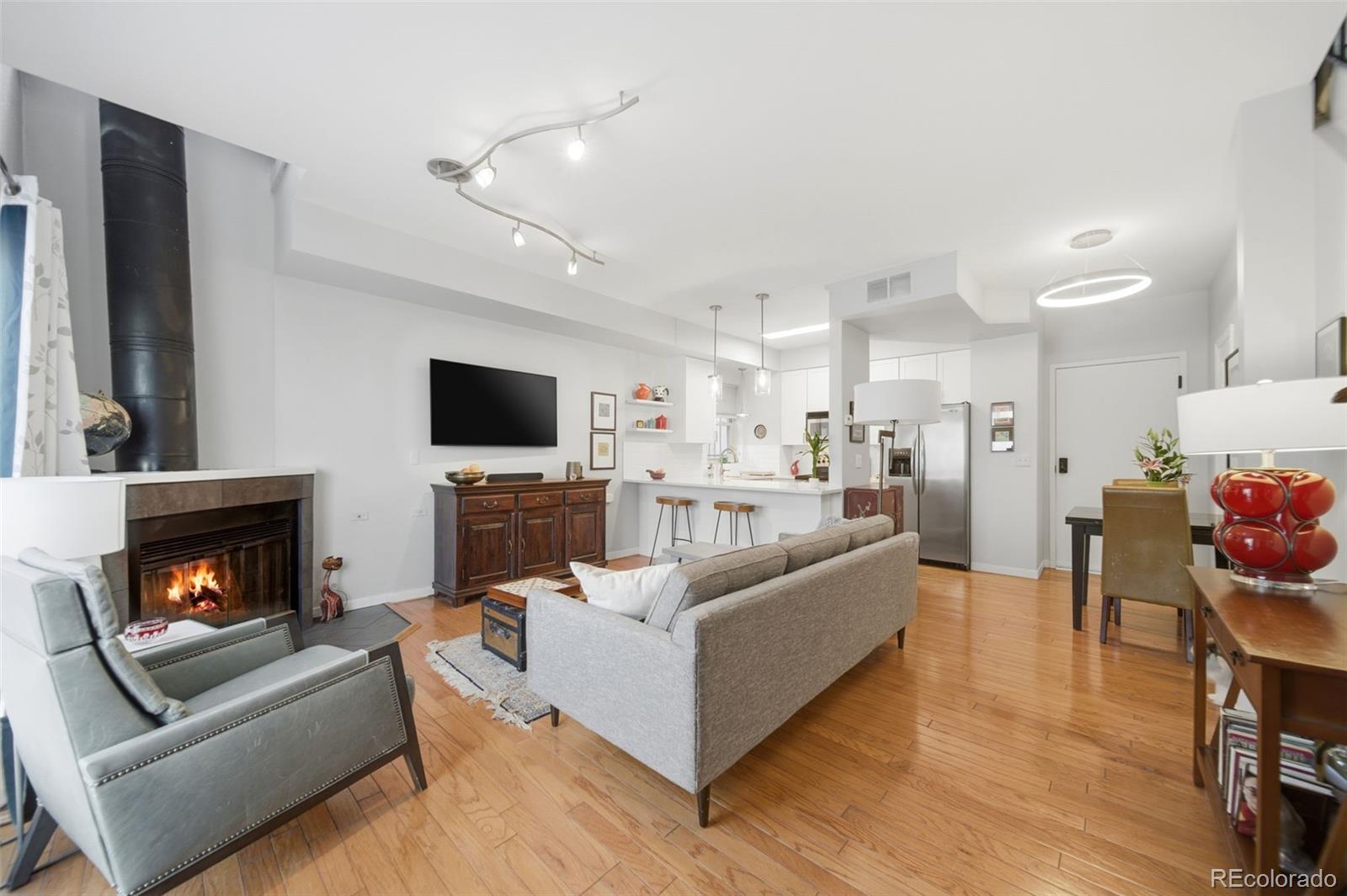 3045 Umatilla Street Denver, CO 80211 - Photo 3 of 48 a living room with furniture and a fireplace