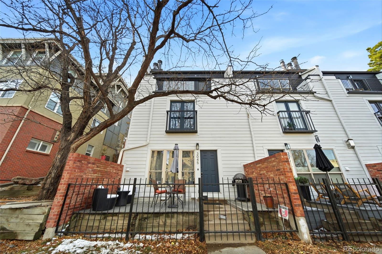 3045 Umatilla Street Denver, CO 80211 - Photo 33 of 48 a view of a brick house with many windows