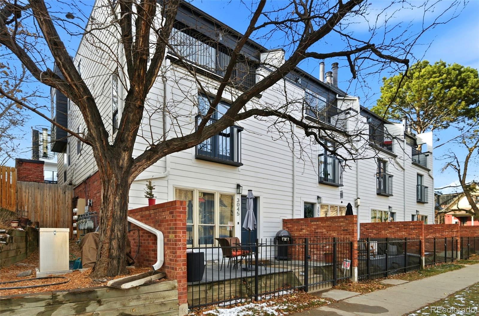 3045 Umatilla Street Denver, CO 80211 - Photo 41 of 48 a front view of a building with large trees