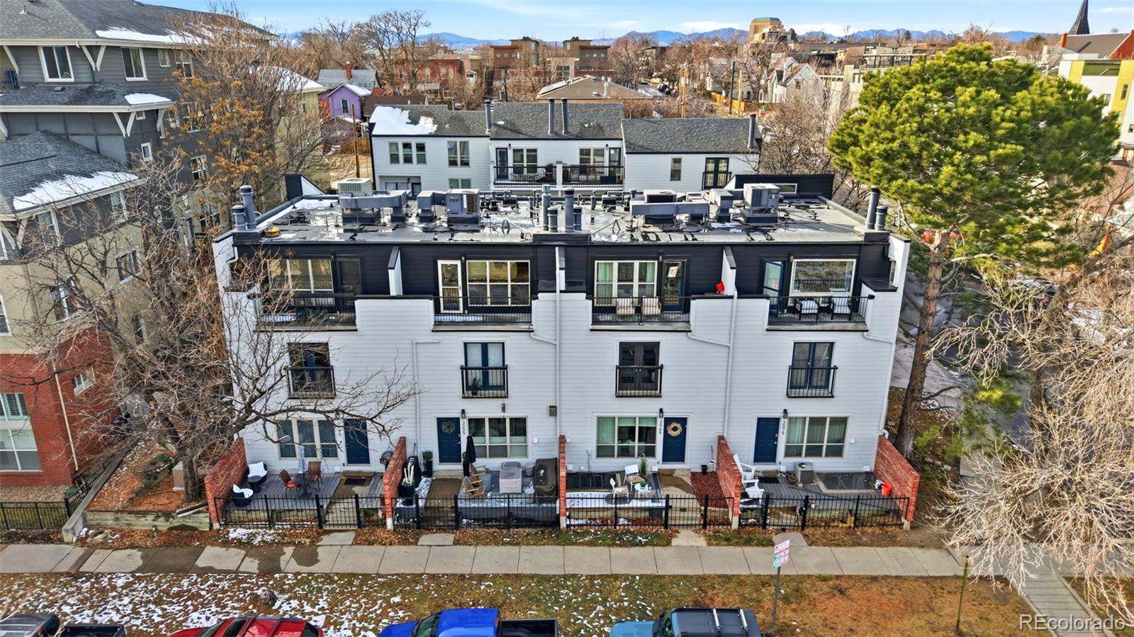 3045 Umatilla Street Denver, CO 80211 - Photo 44 of 48 a front view of a building with a swimming pool and outdoor seating
