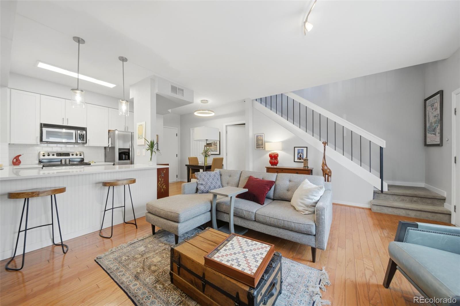 3045 Umatilla Street Denver, CO 80211 - Photo 6 of 48 a living room with furniture and a dining table with wooden floor