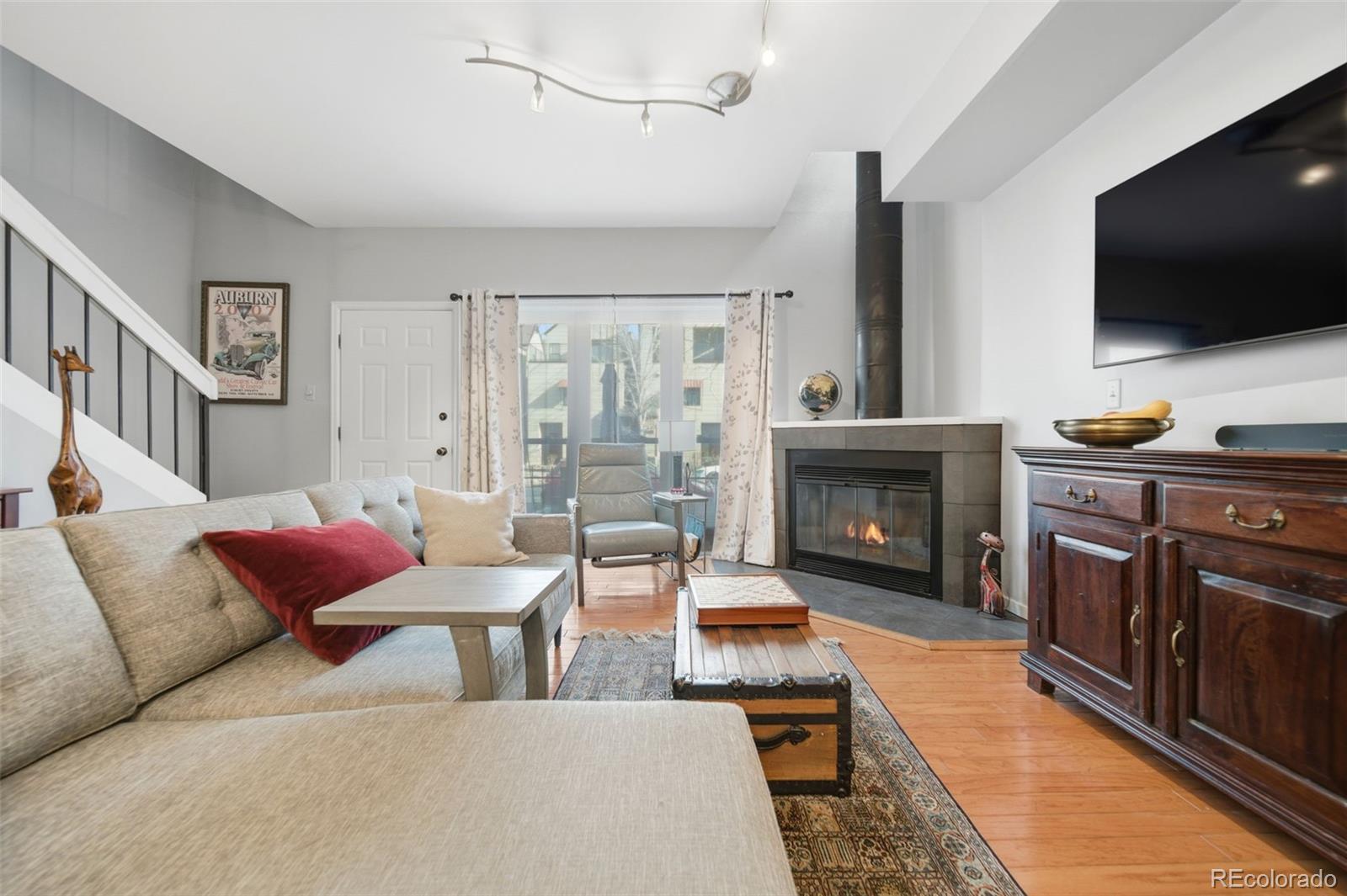 3045 Umatilla Street Denver, CO 80211 - Photo 7 of 48 a living room with furniture a flat screen tv and a fireplace