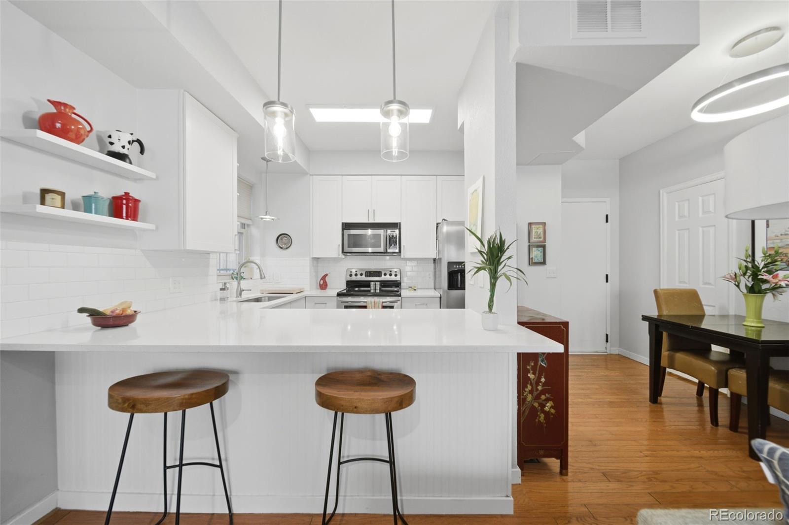 3045 Umatilla Street Denver, CO 80211 - Photo 9 of 48 a kitchen with cabinets and wooden floor
