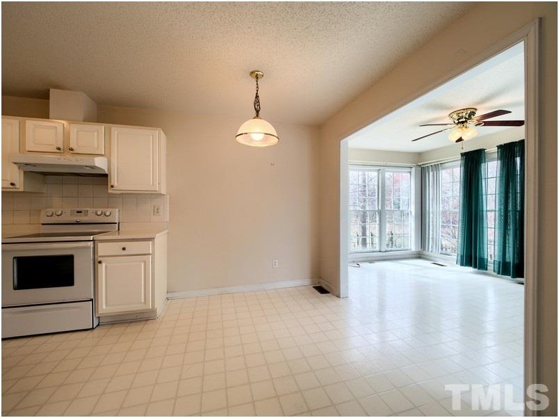 9513 Cub Trail Raleigh, NC 27615 - Photo 7 of 8 a view of a kitchen with a stove cabinets and a kitchen counter space