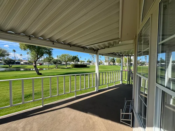 a view of a porch with furniture and garden