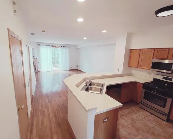 a kitchen that has a sink a stove and a refrigerator