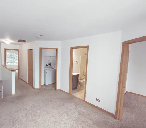 an empty room with windows and closet