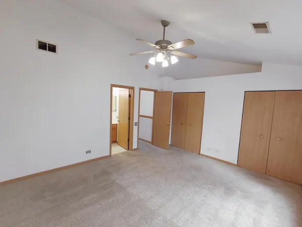 a view of an empty room with a ceiling fan