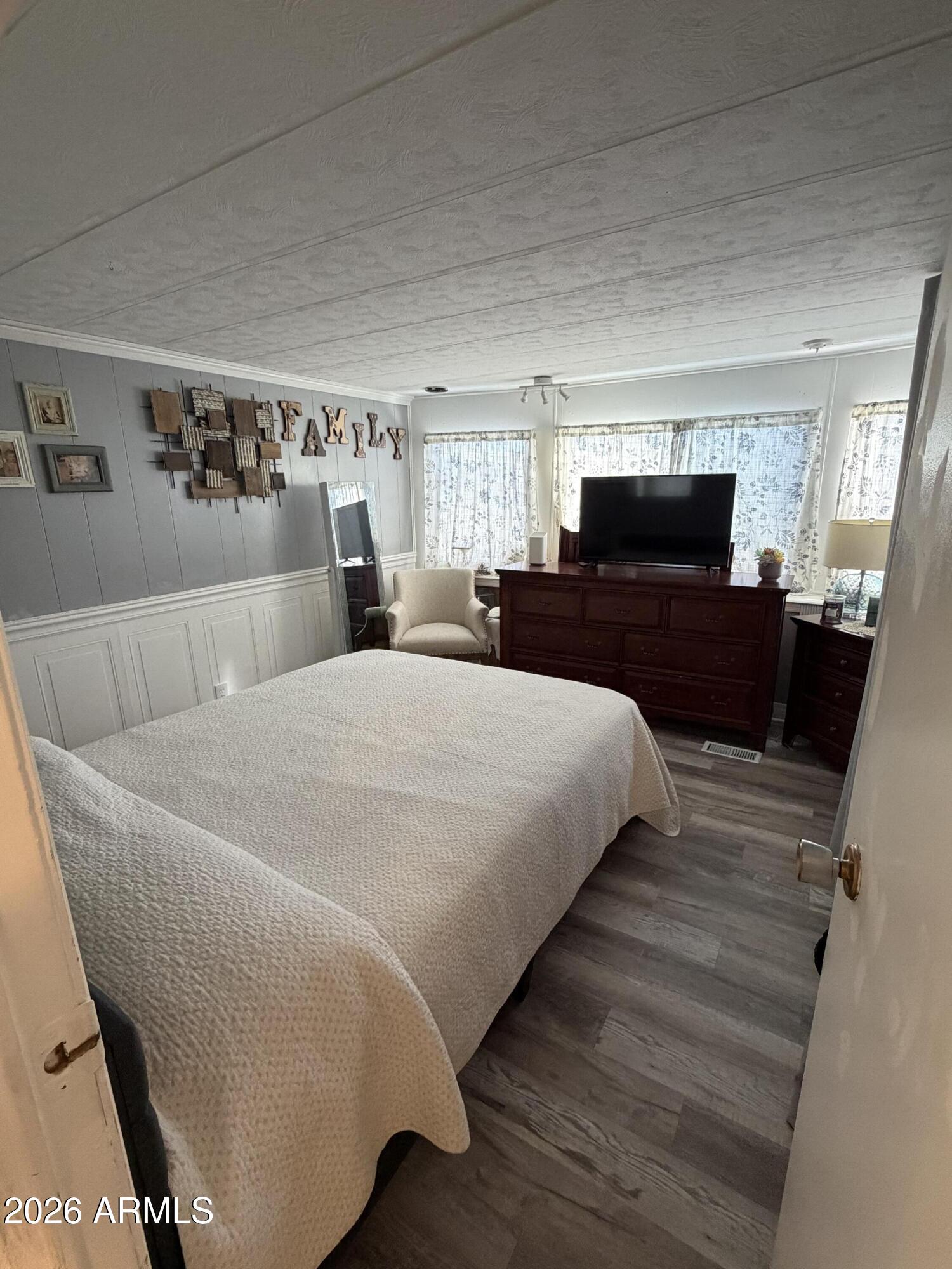 3104 East Broadway Road North, Unit 307 Mesa, AZ 85204 - Photo 11 of 11 a spacious bedroom with a bed and a couch