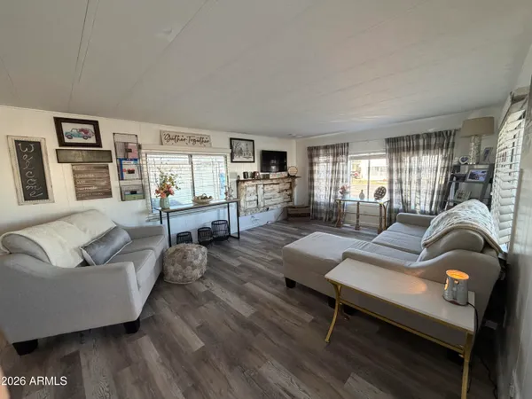 a living room with furniture and a wooden floor