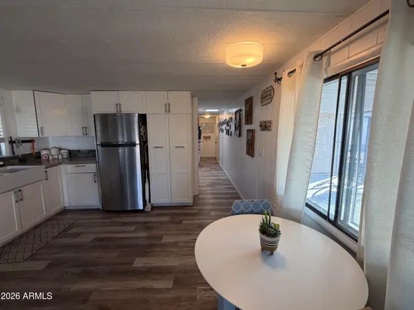 a kitchen with refrigerator and windows