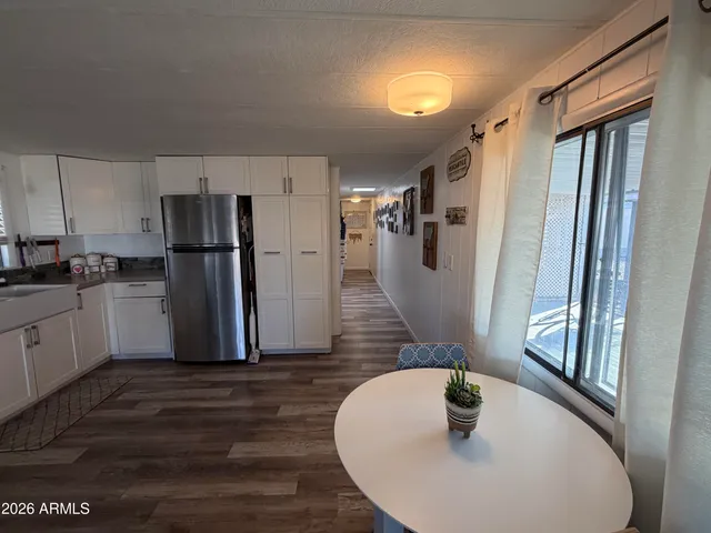 a kitchen with refrigerator and windows