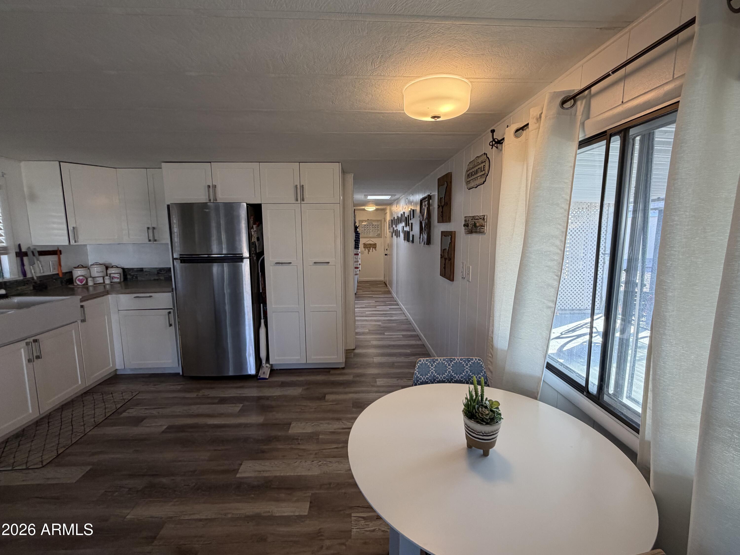 3104 East Broadway Road North, Unit 307 Mesa, AZ 85204 - Photo 6 of 11 a kitchen with refrigerator and windows