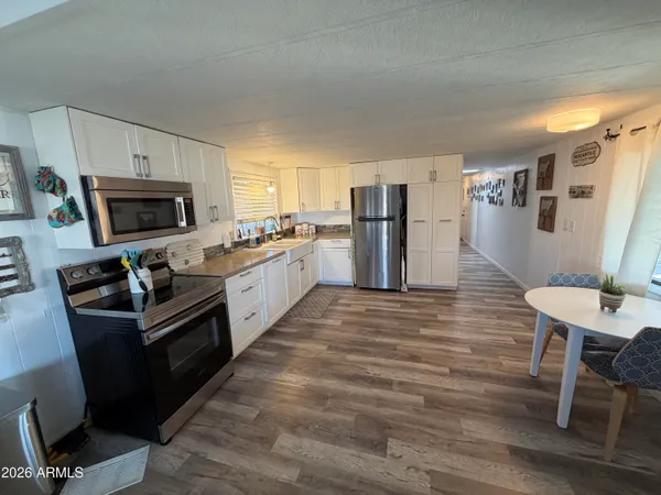 a kitchen with a refrigerator a stove top oven a sink and dishwasher