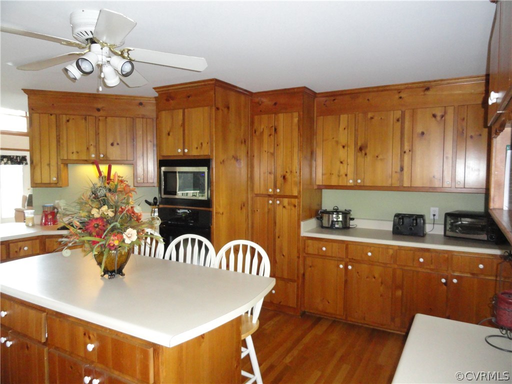 17908 Courthouse Road Dinwiddie, VA 23841 - Photo 8 of 49 a kitchen with stainless steel appliances granite countertop a sink dishwasher and a stove with wooden floor