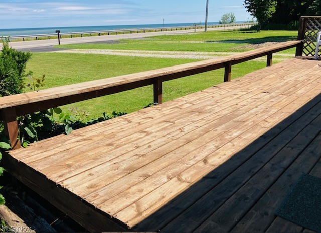 4374 Lake Road East Geneva, OH 44041 - Photo 14 of 19 Wooden terrace featuring a water view and a yard