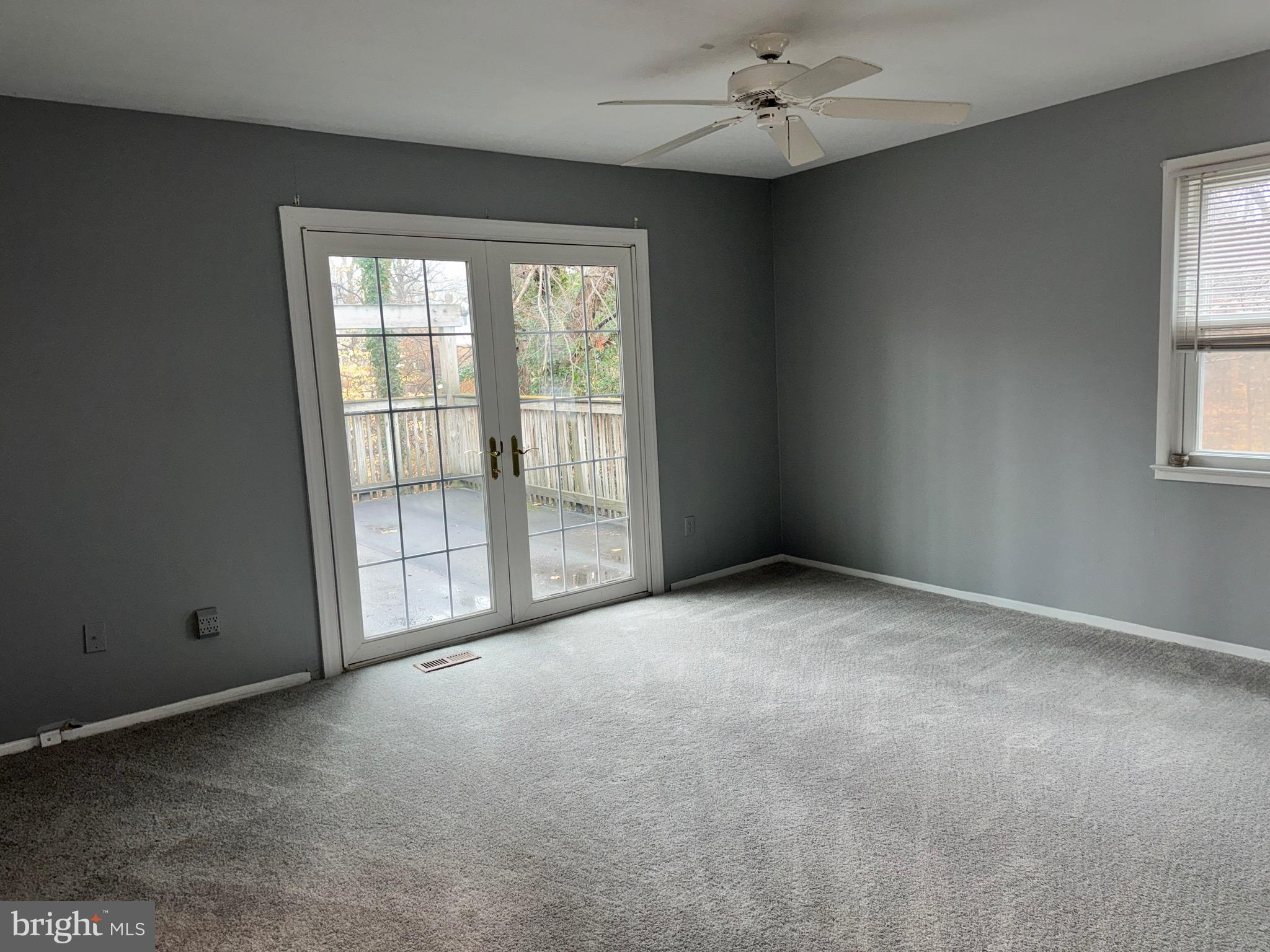 6703 Greenview Lane Springfield, VA 22152 - Photo 16 of 41 an empty room with windows and chandelier fan
