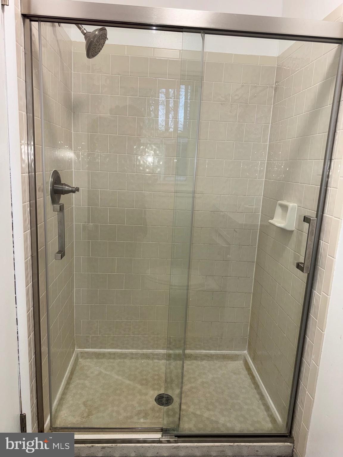 6703 Greenview Lane Springfield, VA 22152 - Photo 22 of 41 a bathroom with a glass shower door