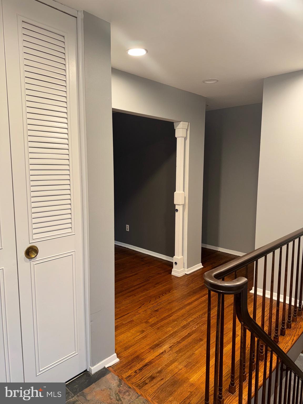 6703 Greenview Lane Springfield, VA 22152 - Photo 3 of 41 a view of a hallway with wooden floor and stairs
