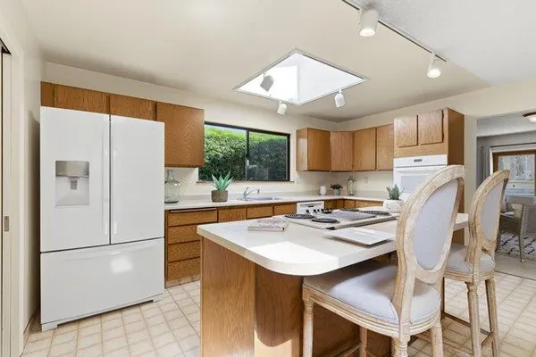 a kitchen with a sink stainless steel appliances and cabinets