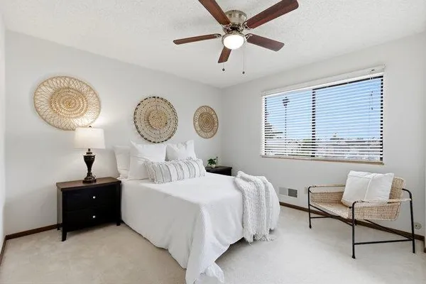a bedroom with a bed and a painting on the wall