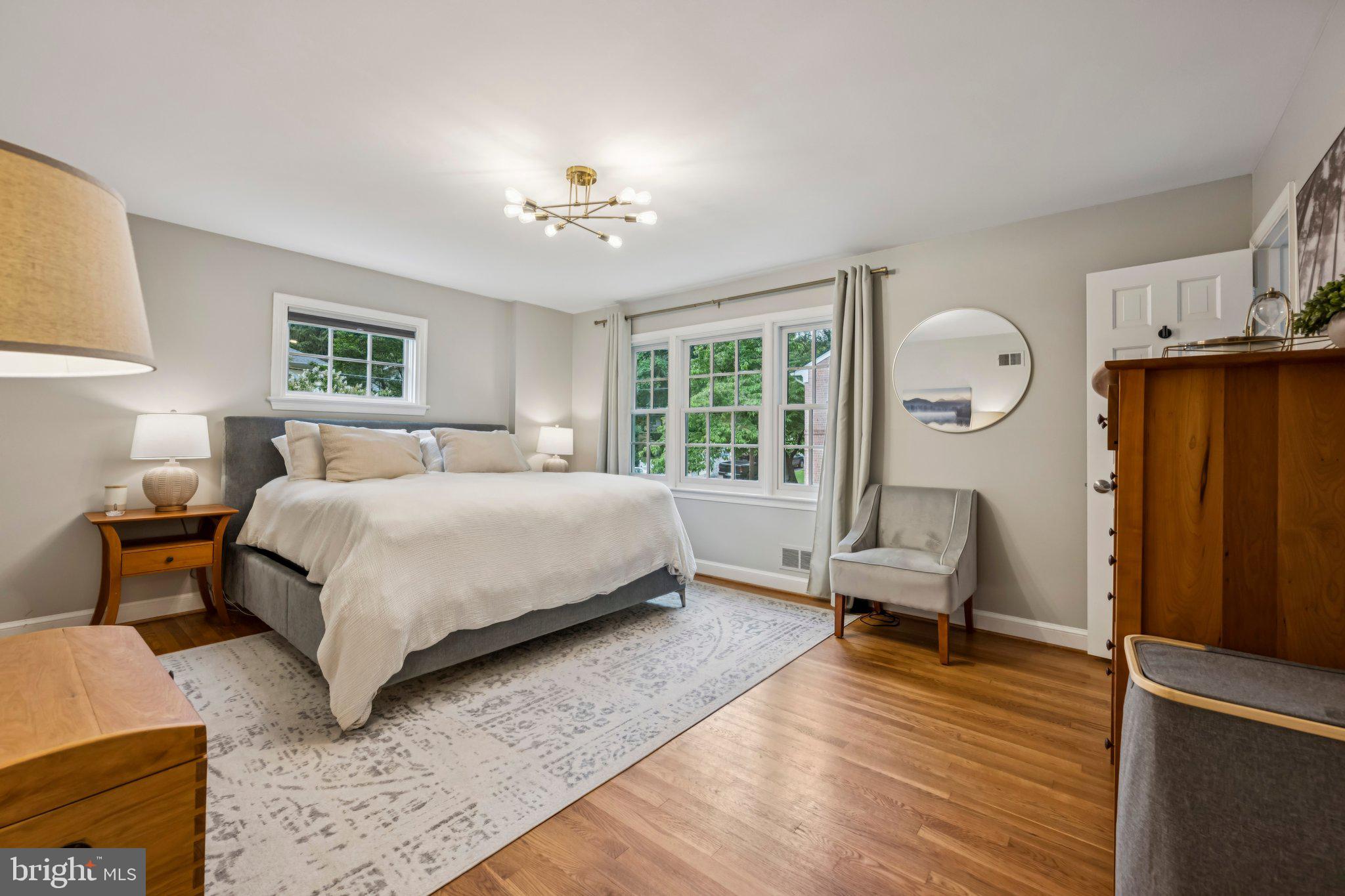 5109 River Hill Road Bethesda, MD 20816 - Photo 12 of 21 a bedroom with a bed a chandelier and a window