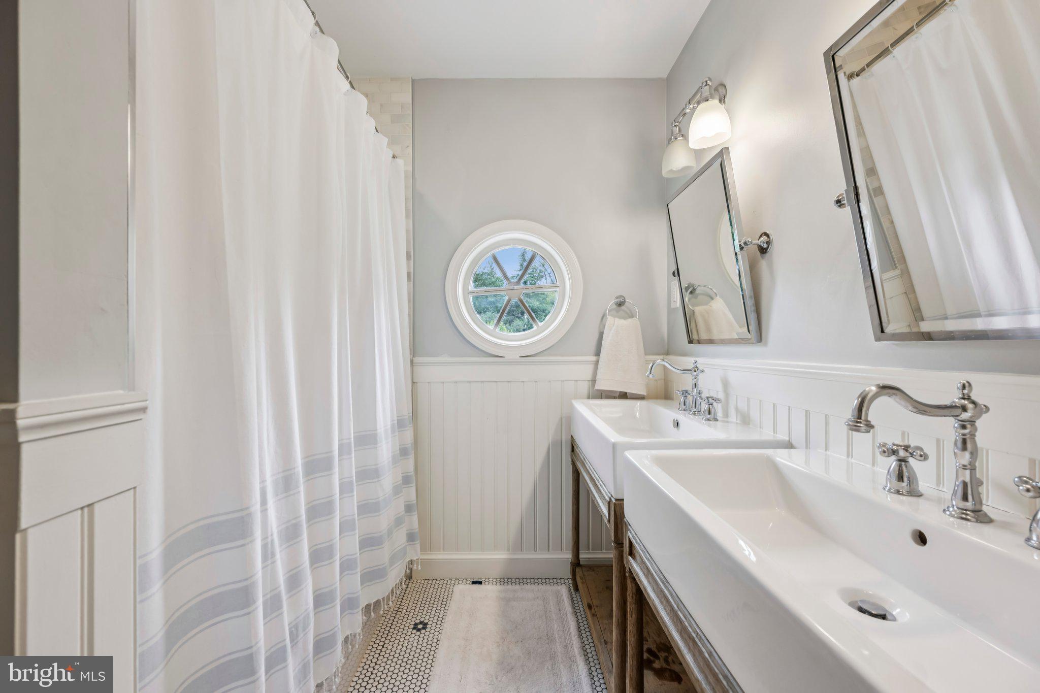 5109 River Hill Road Bethesda, MD 20816 - Photo 18 of 21 a bathroom with a sink and a mirror