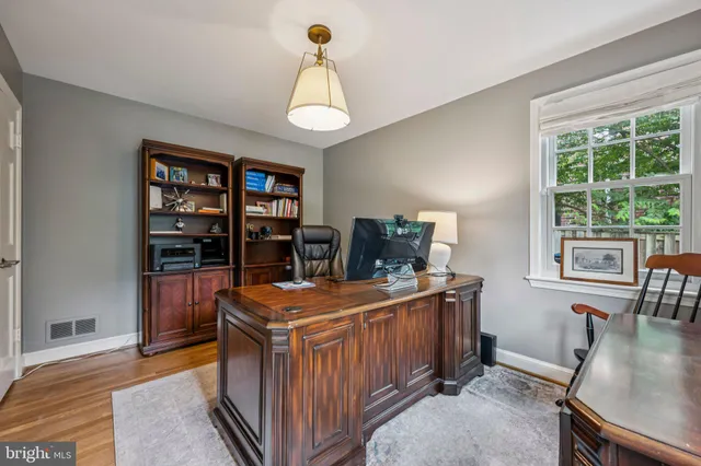 a room with furniture a bookshelf and a window