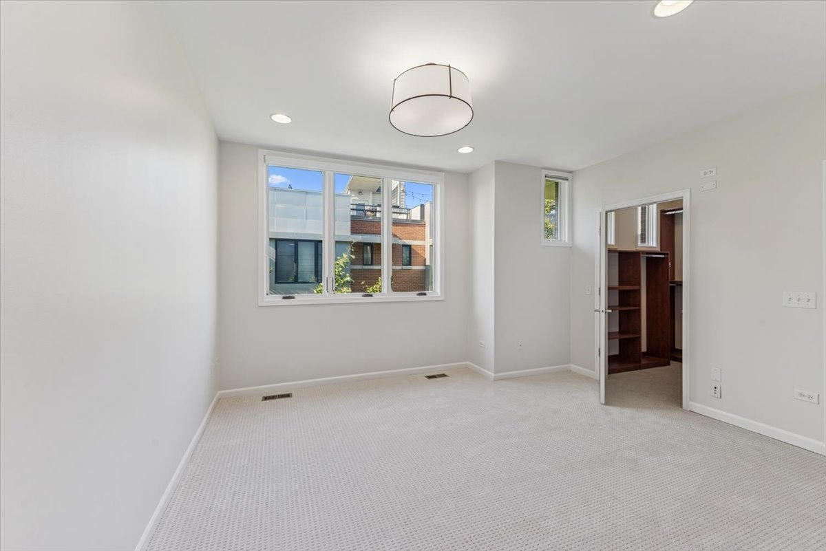2225 West Madison Street, Unit 7 Chicago, IL 60612 - Photo 14 of 32 an empty room with closet and windows