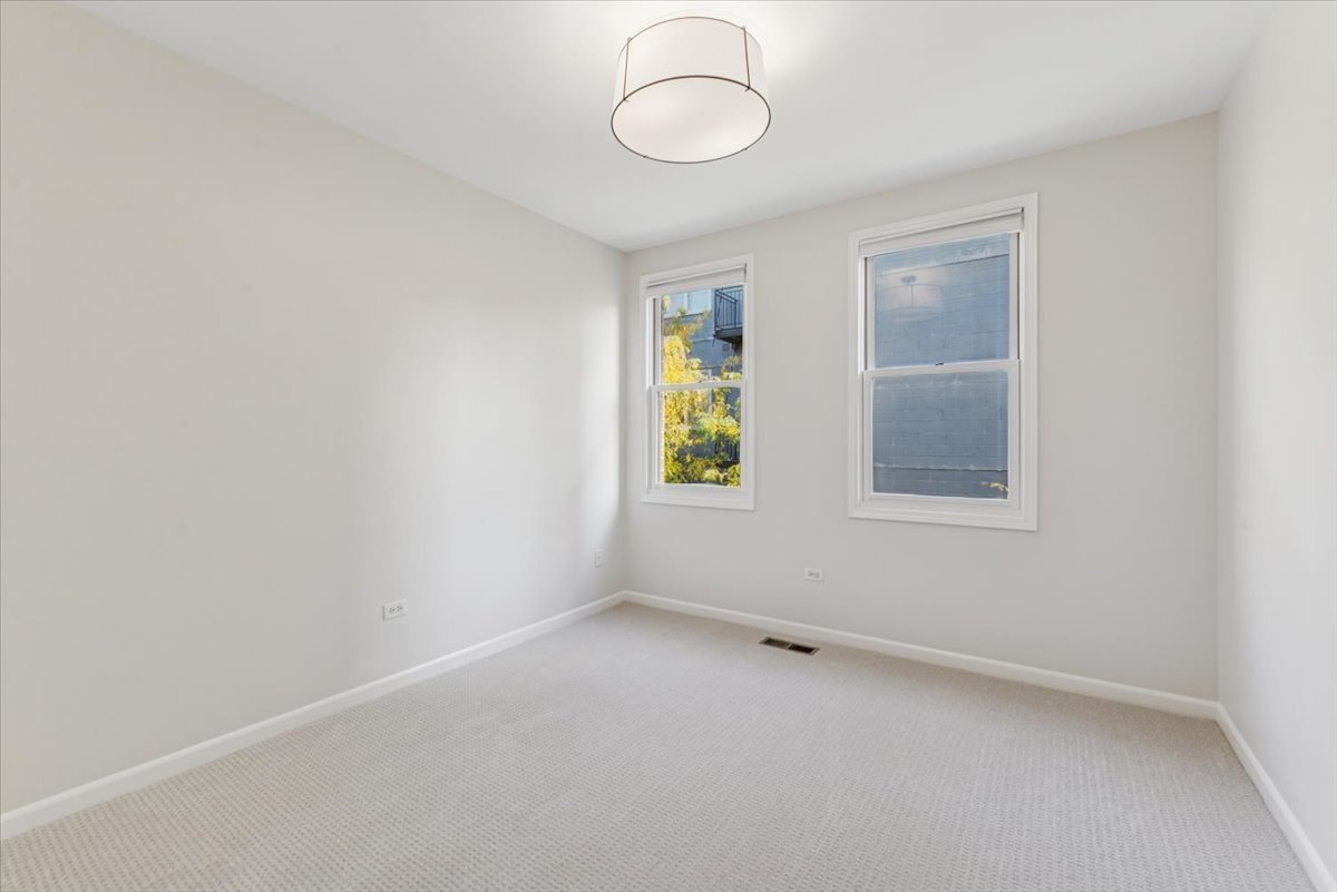 2225 West Madison Street, Unit 7 Chicago, IL 60612 - Photo 17 of 32 an empty room with windows