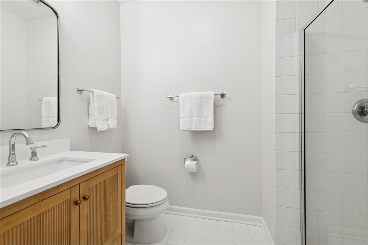2225 West Madison Street, Unit 7 Chicago, IL 60612 - Photo 18 of 32 a bathroom with a sink toilet and vanity