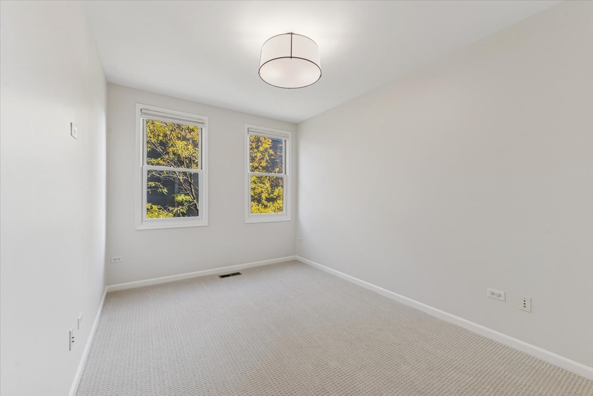 2225 West Madison Street, Unit 7 Chicago, IL 60612 - Photo 19 of 32 an empty room with windows