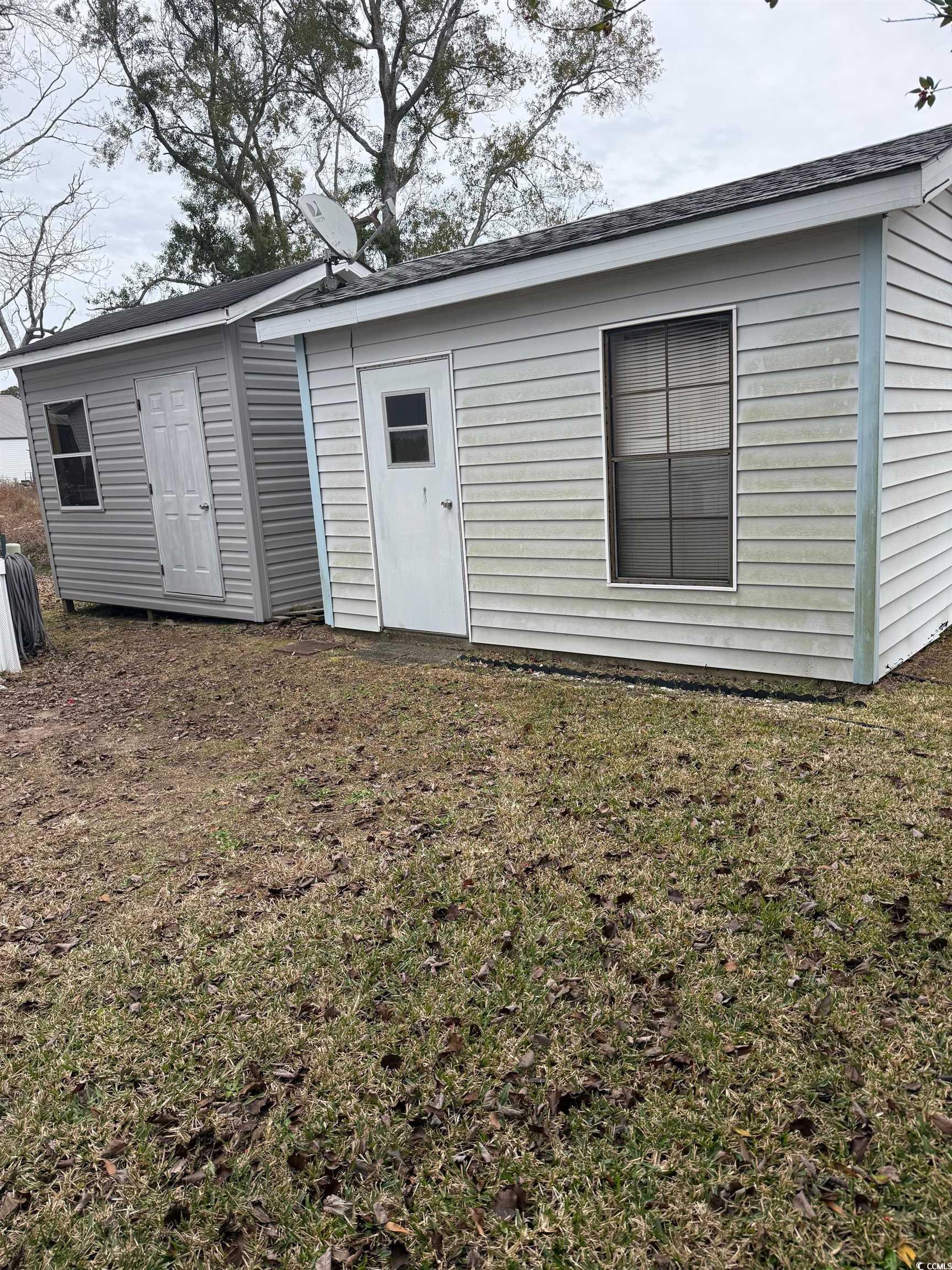 159 Crooked Island Circle Murrells Inlet, SC 29576 - Photo 4 of 20 Back of house with a lawn and roof with shingles