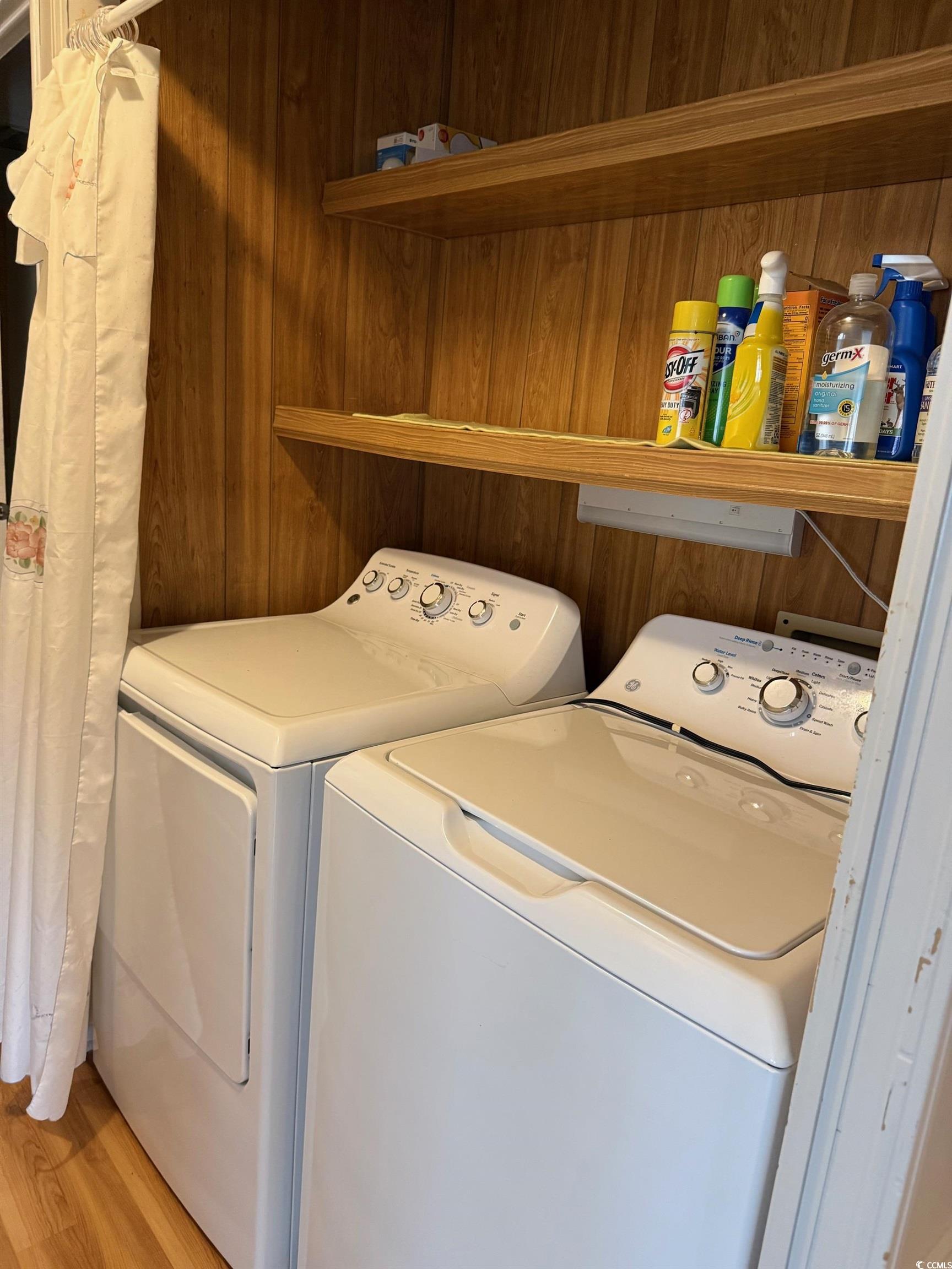 159 Crooked Island Circle Murrells Inlet, SC 29576 - Photo 9 of 20 Laundry room featuring washing machine and dryer, light wood-style floors, and wood walls