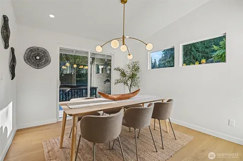 a workspace room with wooden floor and furniture