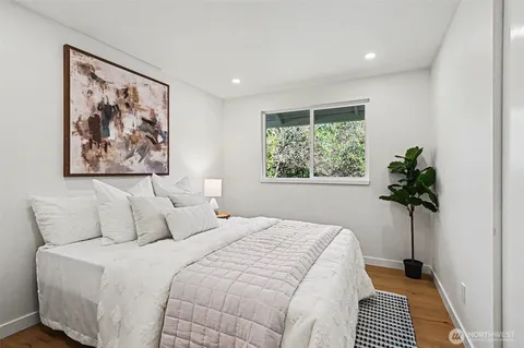 a view of a house with a wooden deck and yard