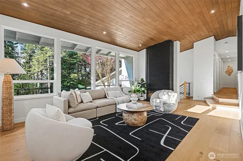a living room with furniture and a floor to ceiling window