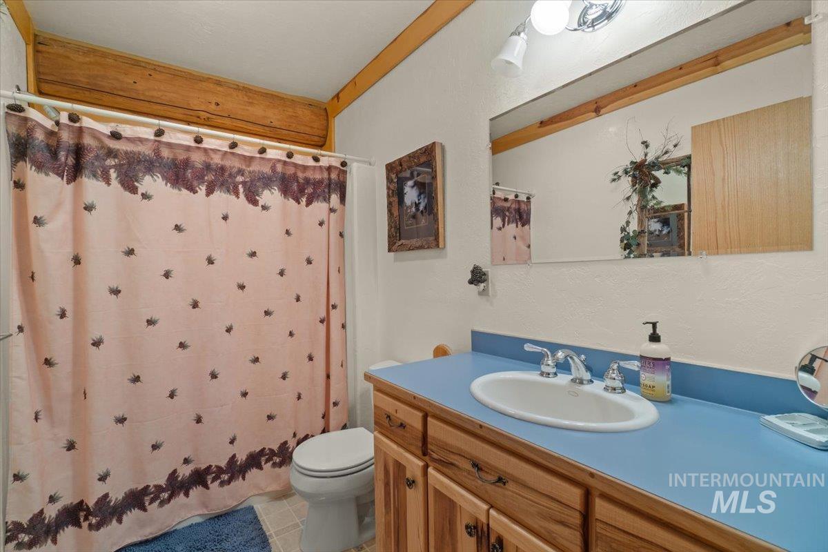 3725 Rim Road New Meadows, ID 83654 - Photo 23 of 50 Full bath featuring vanity, curtained shower, and light tile patterned flooring